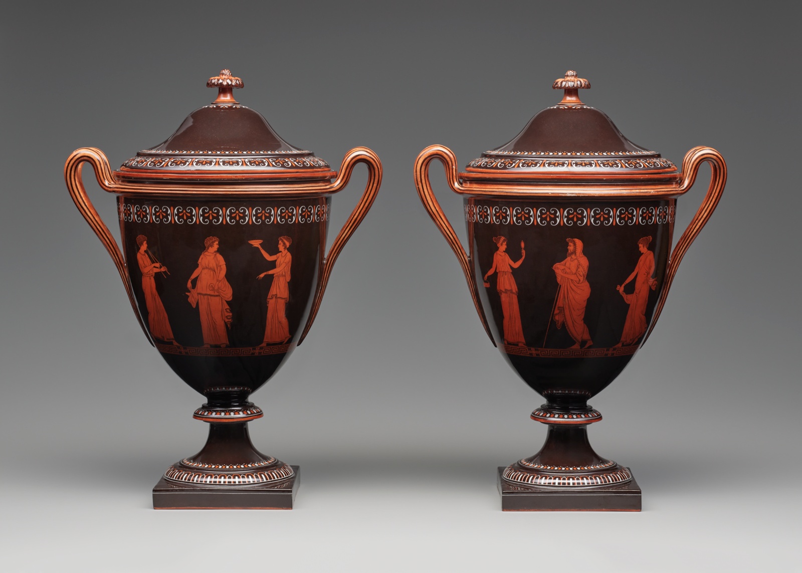 A pair of porcelain ice coolers, lidded and handled